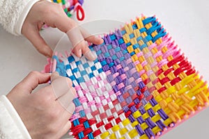 Childrens creativity weaving with colored threads ropes