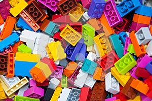 Childrens Designer Background. Multicolored plastic building blocks of the designer.