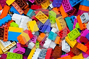 Childrens Designer Background. Multicolored plastic building blocks of the designer.