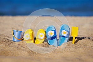 Childrens flip-flops on the beach. Summer vacation concept