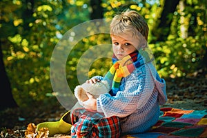 Childrens friendship. Atumn fun at the park. Happy kids autumn. Cute boy with Autumn Leaves on Fall Nature Background