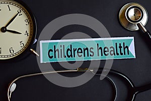 Childrens Health on the print paper with Healthcare Concept Inspiration. alarm clock, Black stethoscope.