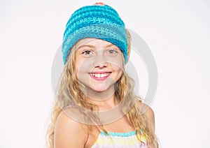 Childrens knitted hats. Girl long hair happy face white background. Kid wear warm soft knitted blue hat. Difference