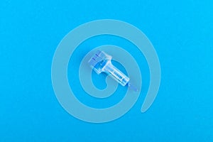 Childrens scarifier for taking blood. The device in the blood sample of the child. On a blue background. blood test with a finger