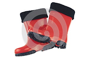 Childrens shoes and boots. Closeup of seasonable red rubber boots or gumboots isolated on a white background. Clipping path. Kids