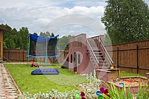 Childrens slide, trampoline and sandbox on the playground