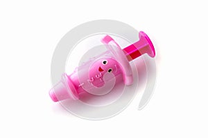 Childrens toy syringe pink isolated object on white background