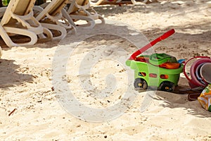 Childrens toys lay in the sand on the beach