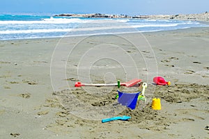 Childrens toys laying on the beach