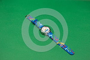 Childrens watch on a green background. Smart watch in blue on a green background