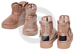 Childrens winter boots. Close-up of two pairs elegant brown suede leather winter boots lined with fur. Girls winter shoe fashion