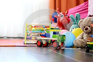 Childrenâ€™s multicolored toys on wooden floor or carpet on kids room