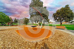 Childrenâ€™s park playground in Suburban Melbourne Victoria Australia. Lovely green grass and nice sunset colours in the sky