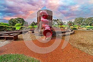 Childrenâ€™s park playground in Suburban Melbourne Victoria Australia. Lovely green grass and nice sunset colours in the sky