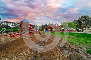 Childrenâ€™s park playground in Suburban Melbourne Victoria Australia. Lovely green grass and nice sunset colours in the sky