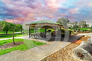 Childrenâ€™s park playground in Suburban Melbourne Victoria Australia. Lovely green grass and nice sunset colours in the sky