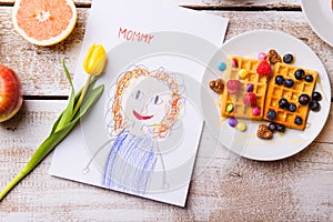 Childs drawing of her mother, yellow tulip, waffles