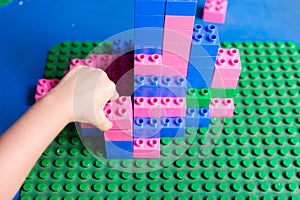 Childs hand while playing lego blocks