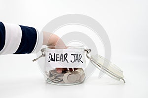 Childs hand right inside the swear jar