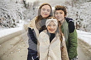 childs having fun in winter snow forest