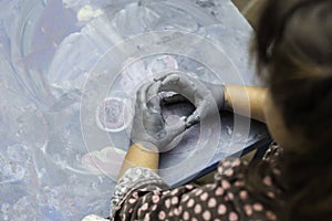 Childs painted hands simulating a circle