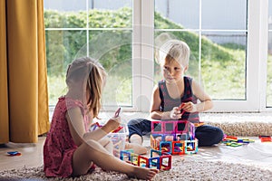 The childs is playing with a multi-colored magnetic constructor, building a tower. Educational toys . A building block for a baby