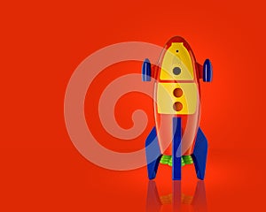 Childs toy rocket on red background