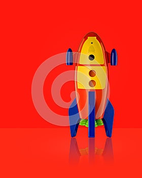 Childs toy rocket on red background