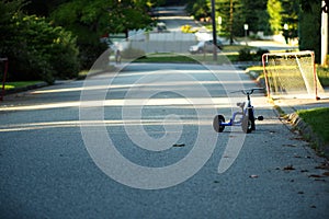 Childs tricycle abandonded on residential street