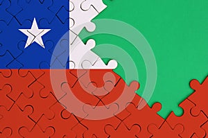 Chile flag is depicted on a completed jigsaw puzzle with free green copy space on the right side