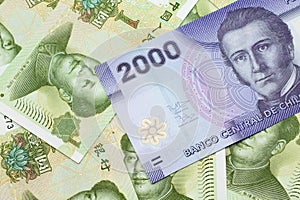 A Chilean 2000 peso bank note on a bed of Chinese one yuan bank notes