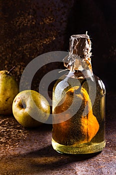 Chilean brandy with whole pear inside bottle. Aguardiente de pera.