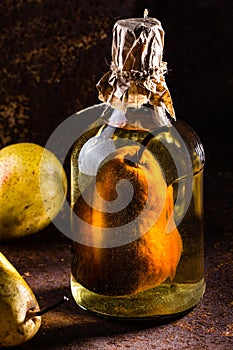 Chilean brandy with whole pear inside bottle. Aguardiente de pera.