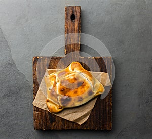 Chilean empanada de pino on wooden board