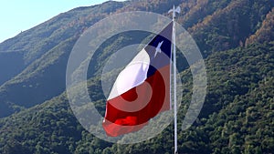 Chilean flag flies in light breeze facing left - slow motion