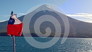 Chilean flag with Osorno volcano on back, in Puerto Varas, south of Chile