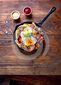 CHILEAN FOOD. CHORRILLANA - french fries topped with beef sliced, tipical sausages chorrisos, fried onion and eggs