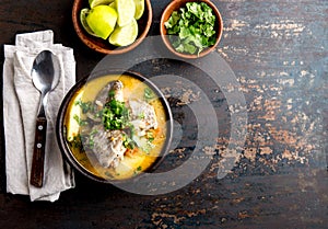 CHILEAN FOOD. Fish soup CALDILLO DE CONGRIO served in clay bowl, top view. copy space