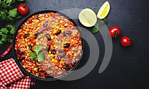 Chili con carne with beef, red beans, paprika, corn and hot peppers in tomato sauce, spicy tex-mex dish in a cooking pot, black