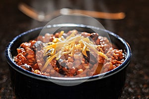 Chili con carne with cheese in a bowl