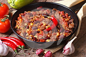 Chili con carne close-up in a frying pan with the ingredients.