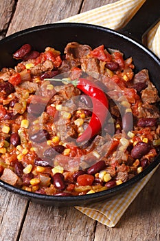 Chili con carne close-up in a frying pan vertical