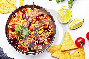 Chili con carne with minced beef, red beans, paprika, sweet corn and hot peppers in spicy tomato sauce, tex-mex cuisine dish,