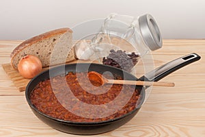 Chili Con Carne in pan on wooden table