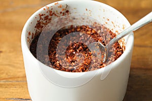 chili flakes in a bowl on table