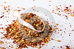 Chili flakes on white table