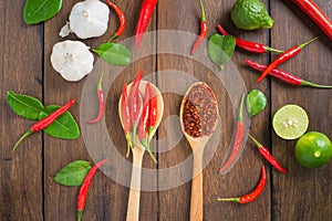 Chili, garlic and lime on wooden background