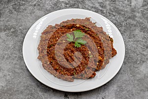 Chili paste on a dark background. spicy paste. A kind of adjika.