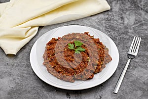 Chili paste on a dark background. spicy paste. A kind of adjika.