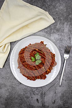 Chili paste on a dark background. spicy paste. A kind of adjika.